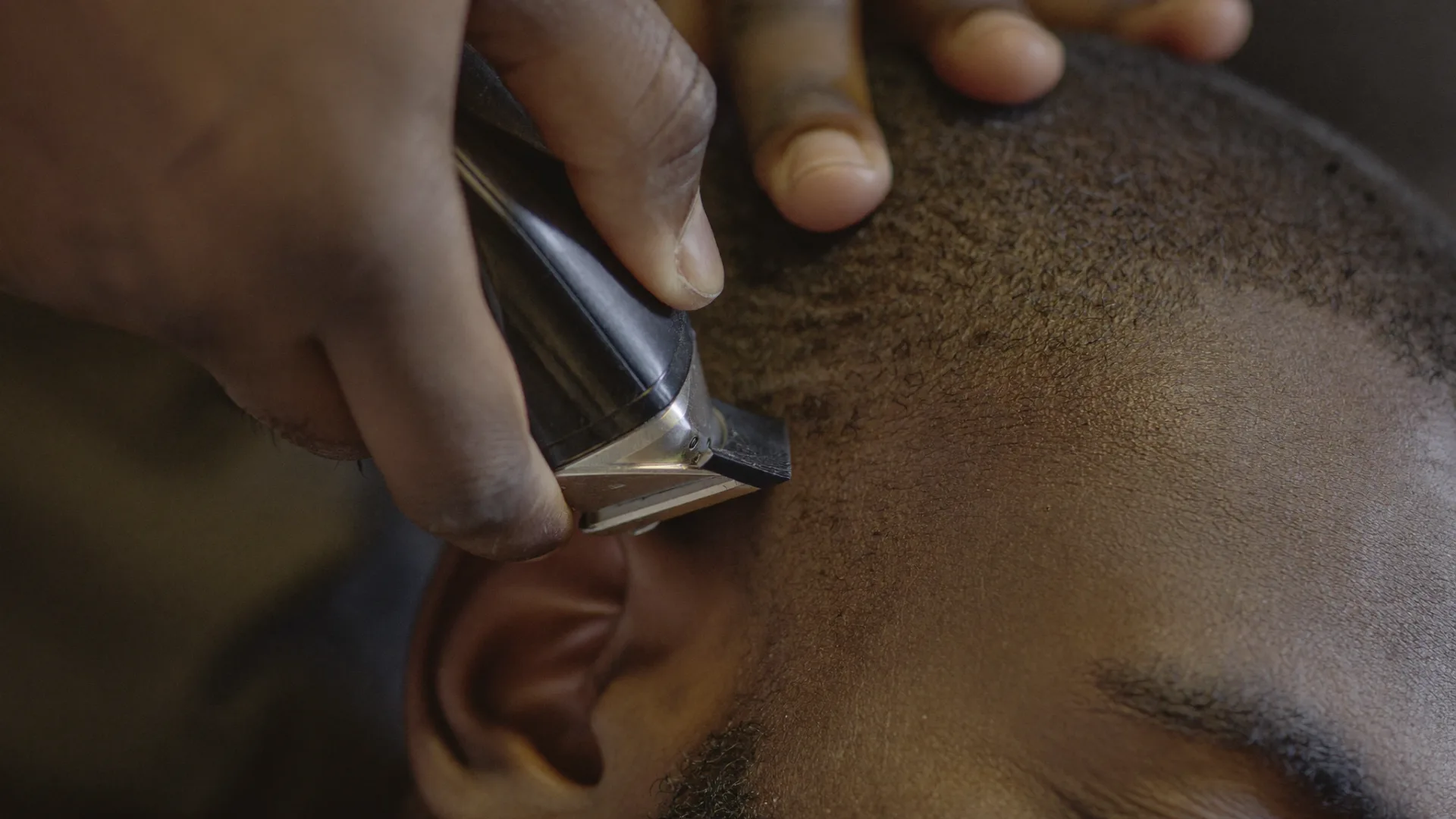 Close-up of a precision fade being cut with clippers