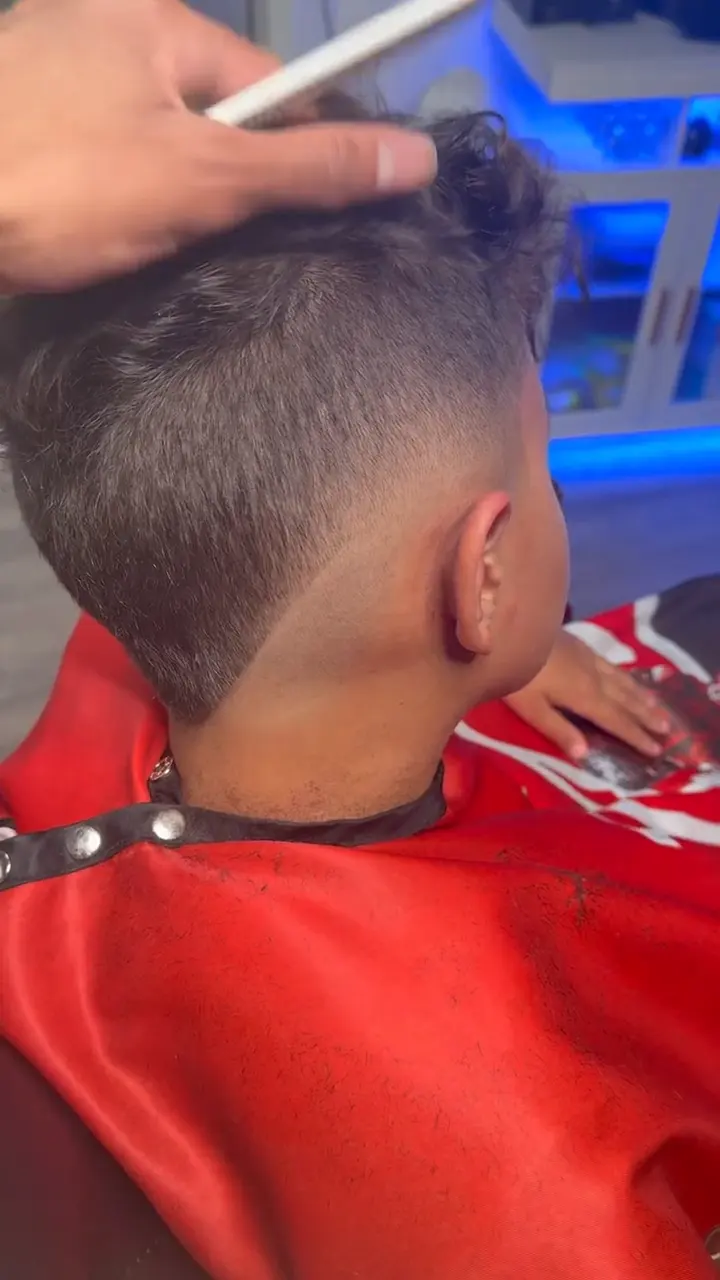 Curly top fade with defined curls left on top and a clean fade underneath