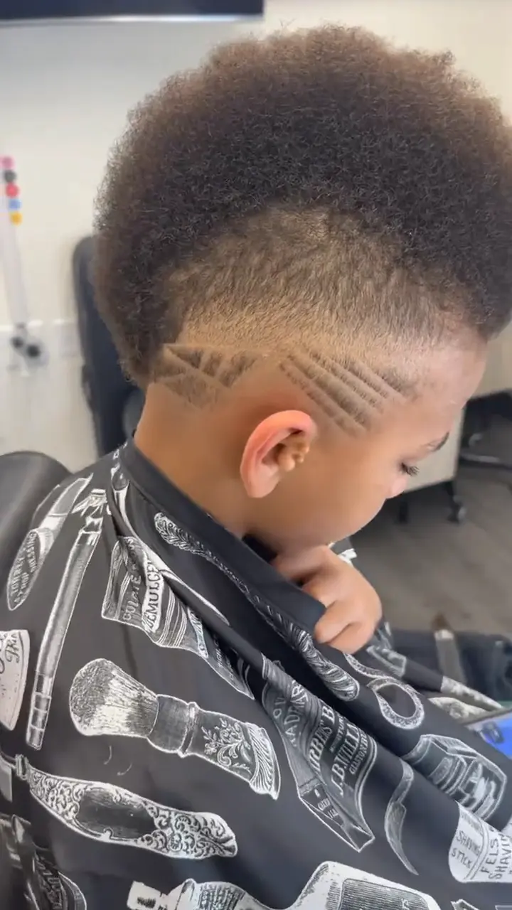 Freestyle hair design carved into an afro with clipper line work