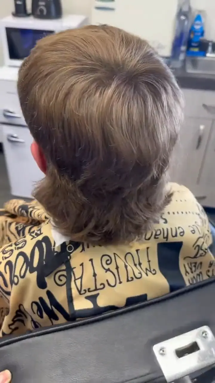 Modern mullet with faded sides and length left through the back
