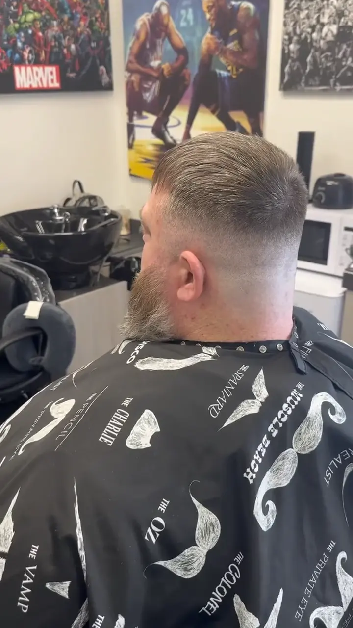 Scissor over comb work shaping the top of a haircut