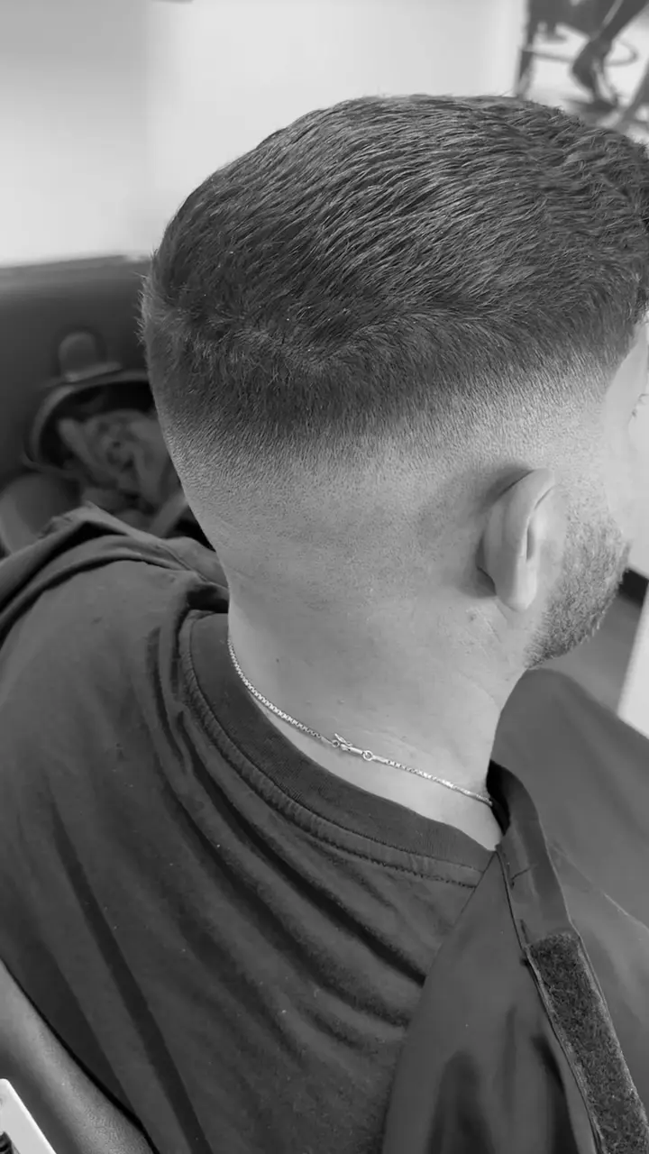 Tight taper fade blended down to the skin with clippers, cut by master barber Anthony Hicks